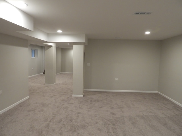 basement featuring light colored carpet