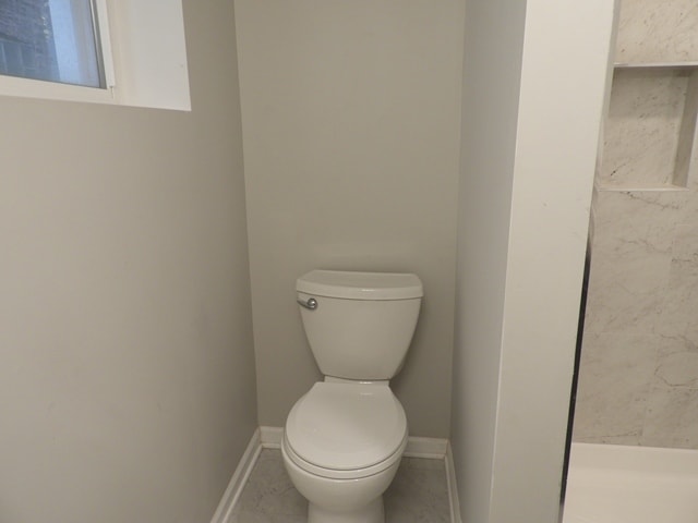 bathroom featuring tile patterned floors and toilet