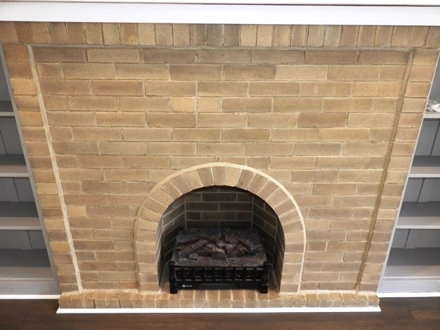 room details with hardwood / wood-style flooring and a brick fireplace