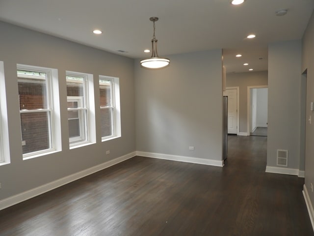 spare room with dark hardwood / wood-style flooring