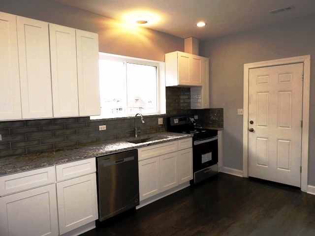 kitchen featuring tasteful backsplash, stainless steel appliances, sink, white cabinets, and dark hardwood / wood-style floors