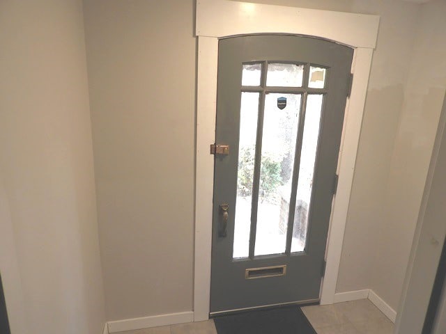 tiled entrance foyer featuring a healthy amount of sunlight