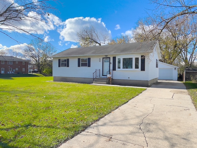 view of front facade featuring a front lawn, an outdoor structure, and a garage