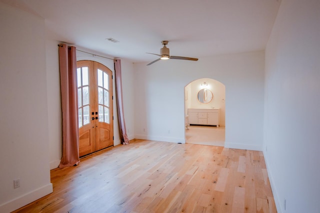 spare room with french doors, light hardwood / wood-style flooring, and ceiling fan