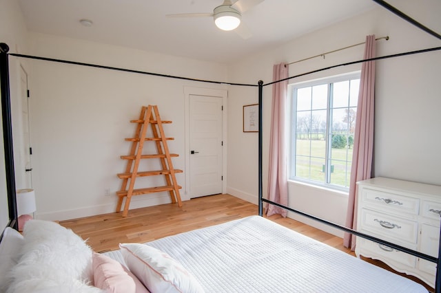 bedroom with ceiling fan and light hardwood / wood-style floors