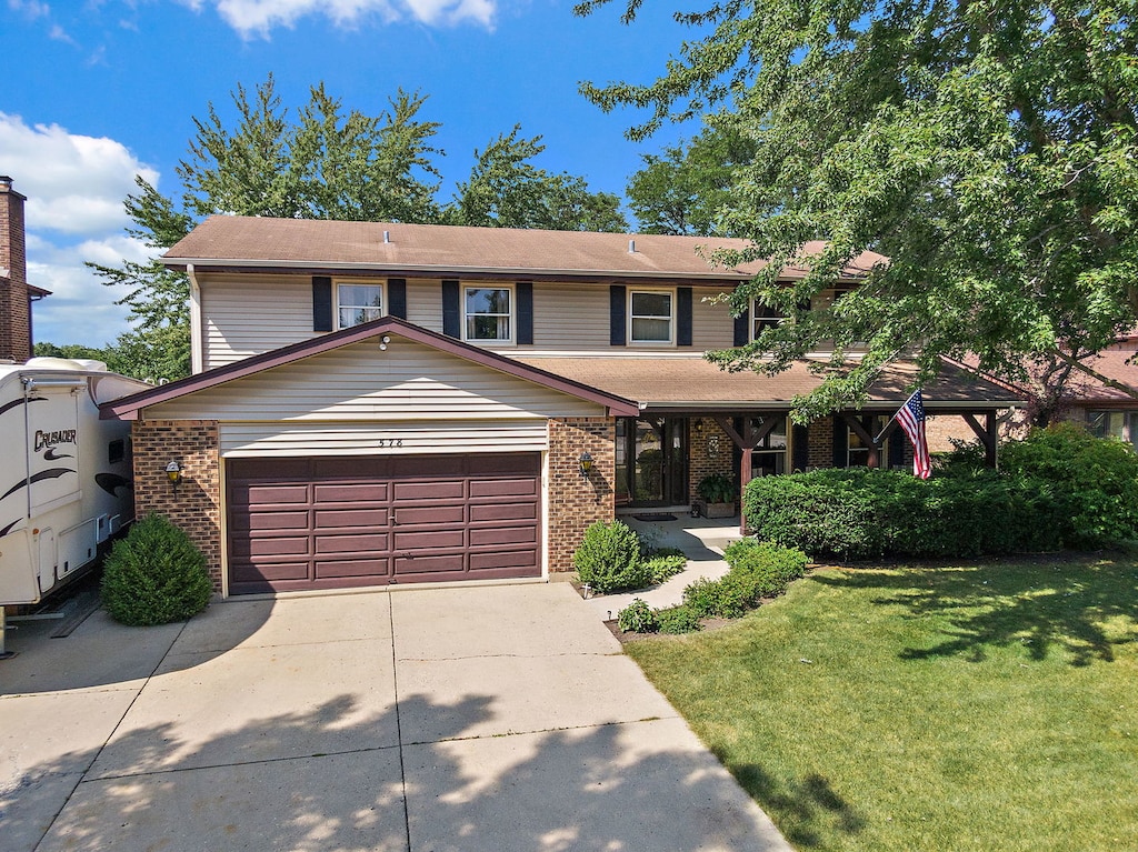 view of front of property featuring a front yard and a garage