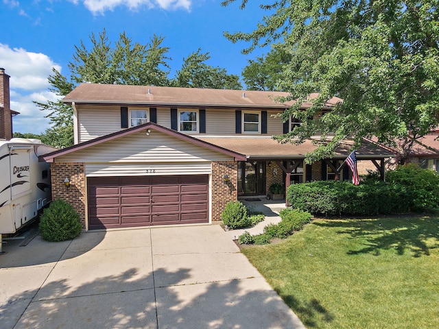 view of front of property featuring a front yard and a garage