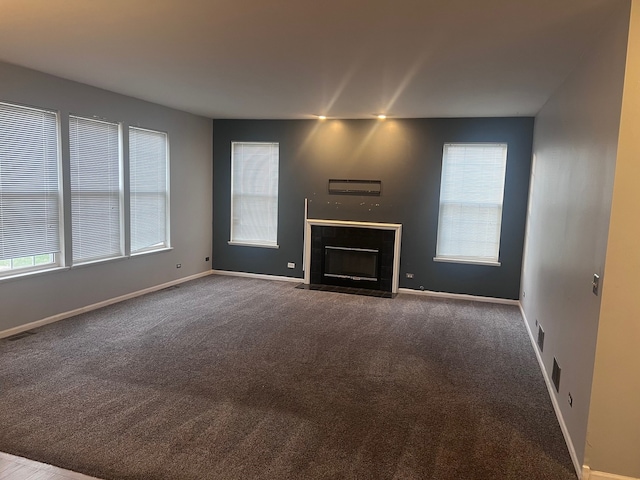 unfurnished living room featuring carpet