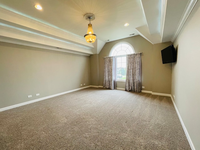 carpeted spare room featuring crown molding and vaulted ceiling