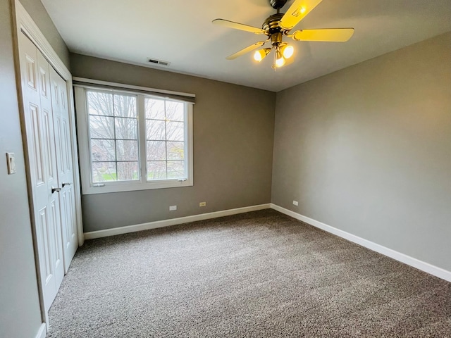 unfurnished bedroom featuring carpet and ceiling fan