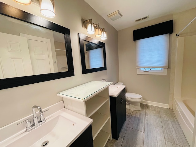 full bathroom featuring vanity, wood-type flooring, bathtub / shower combination, and toilet