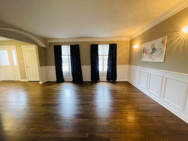 spare room with dark hardwood / wood-style floors and crown molding