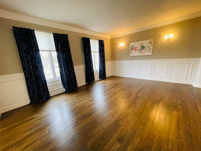 empty room featuring ornamental molding and dark wood-type flooring