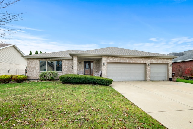 view of front of property with a garage and a front lawn