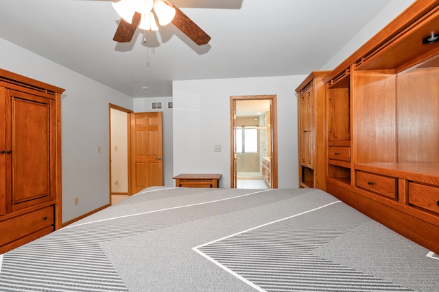 carpeted bedroom with ensuite bathroom and ceiling fan