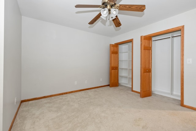 unfurnished bedroom with ceiling fan and light colored carpet