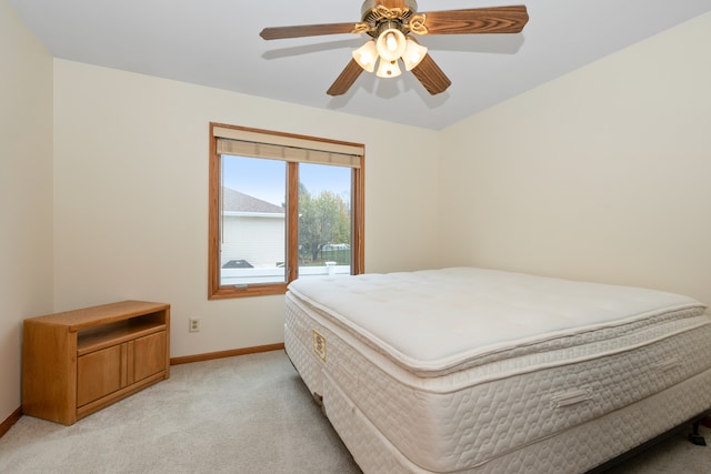 bedroom with ceiling fan and light colored carpet