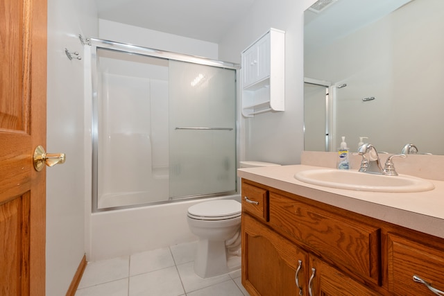 full bathroom with tile patterned flooring, vanity, enclosed tub / shower combo, and toilet