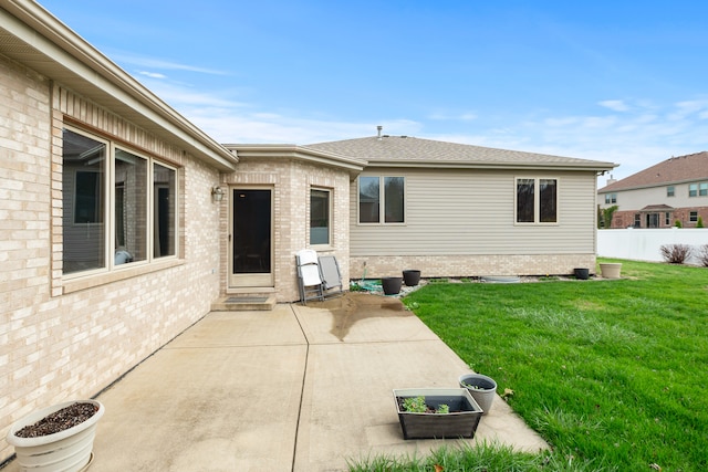 back of house featuring a patio area and a yard