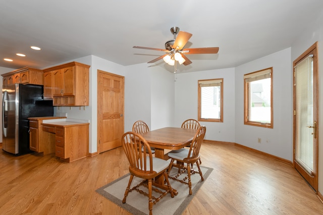 dining area featuring light wood-type flooring and ceiling fan