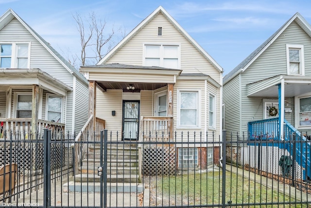 view of front of home with a fenced front yard and a gate