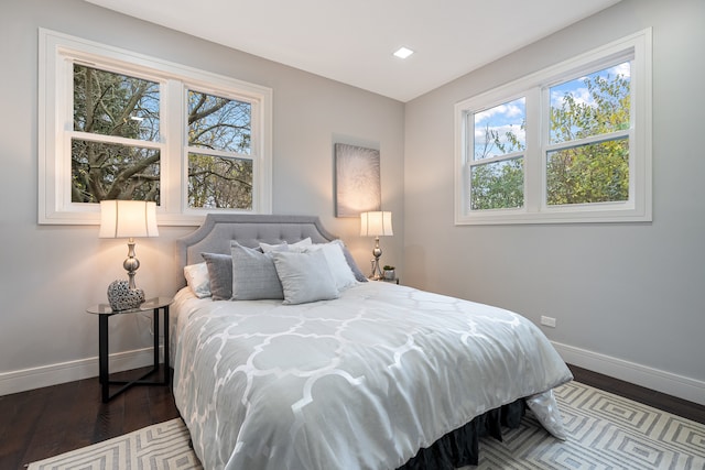 bedroom featuring dark wood-type flooring and multiple windows