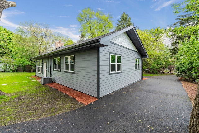 view of property exterior with a lawn