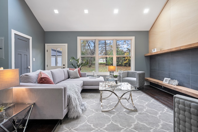 living room with vaulted ceiling and hardwood / wood-style flooring