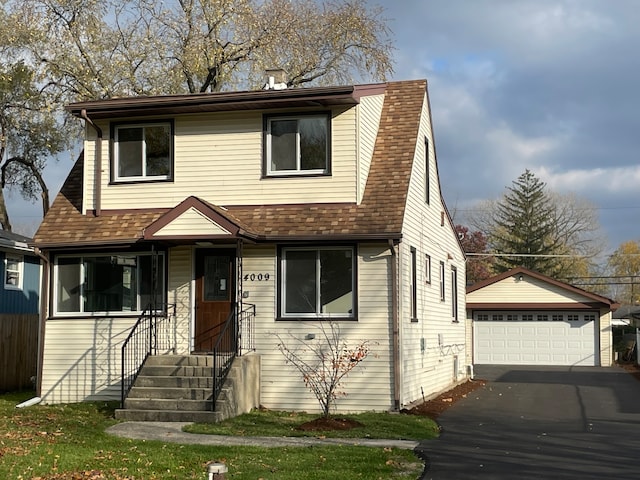 view of front of home with a garage and an outdoor structure