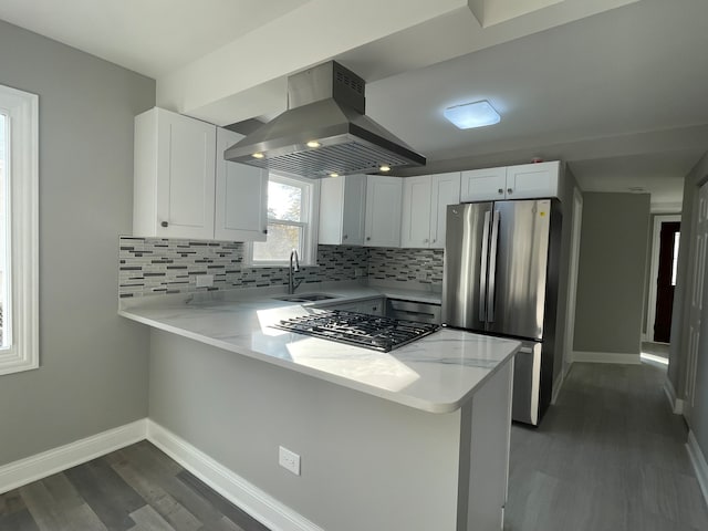 kitchen with white cabinets, sink, island range hood, kitchen peninsula, and stainless steel appliances