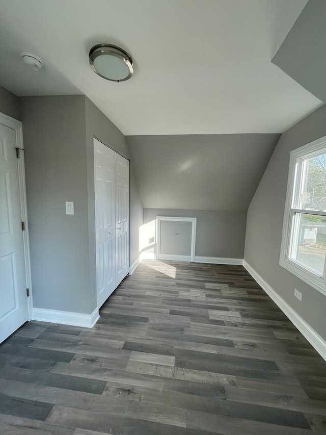 bonus room featuring dark hardwood / wood-style flooring and lofted ceiling