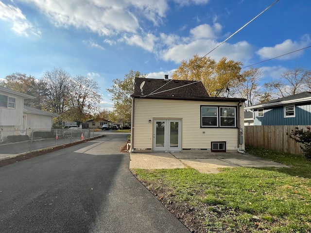 back of property with french doors, a yard, and a patio area