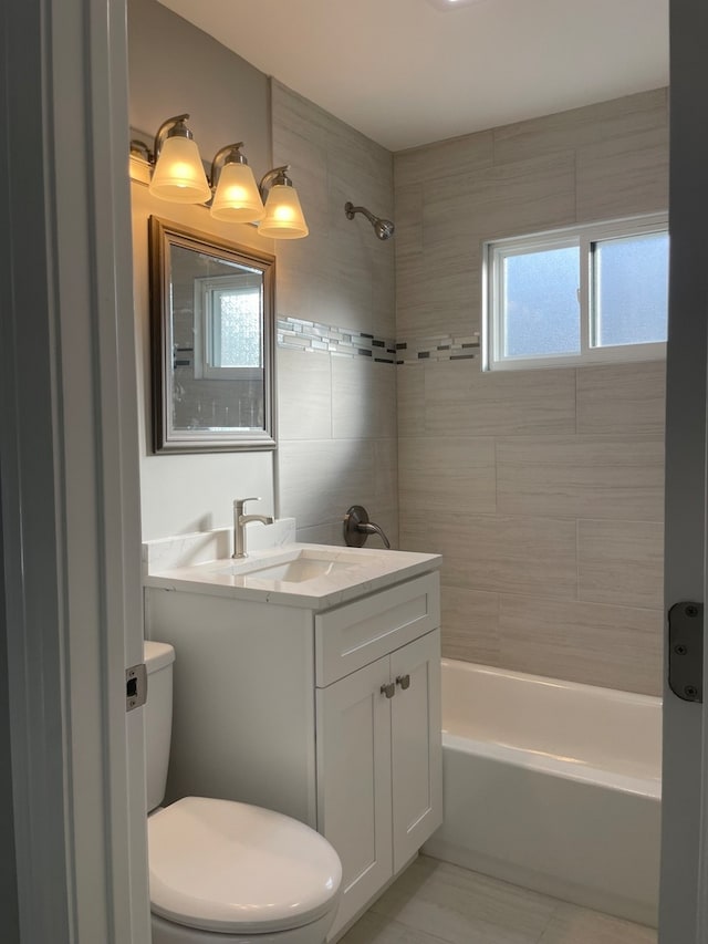 full bathroom featuring vanity, toilet, and tiled shower / bath combo