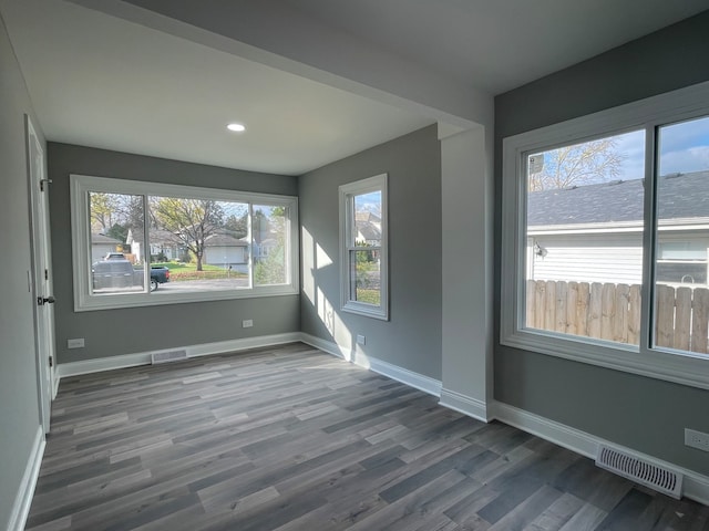 empty room with hardwood / wood-style flooring