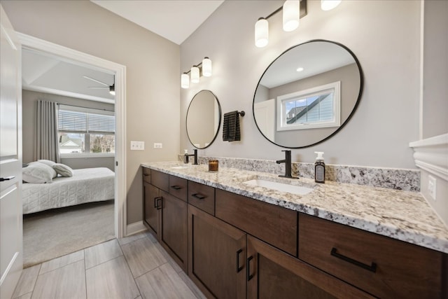 bathroom with ceiling fan and vanity