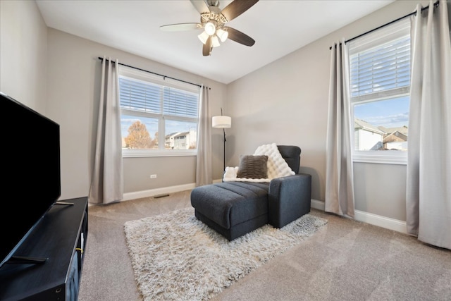 living area featuring ceiling fan and light carpet