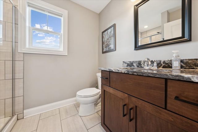 bathroom featuring tile patterned floors, vanity, toilet, and a shower with shower door