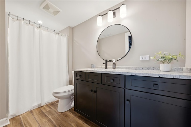 bathroom featuring hardwood / wood-style floors, vanity, and toilet