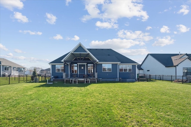 rear view of property featuring a lawn