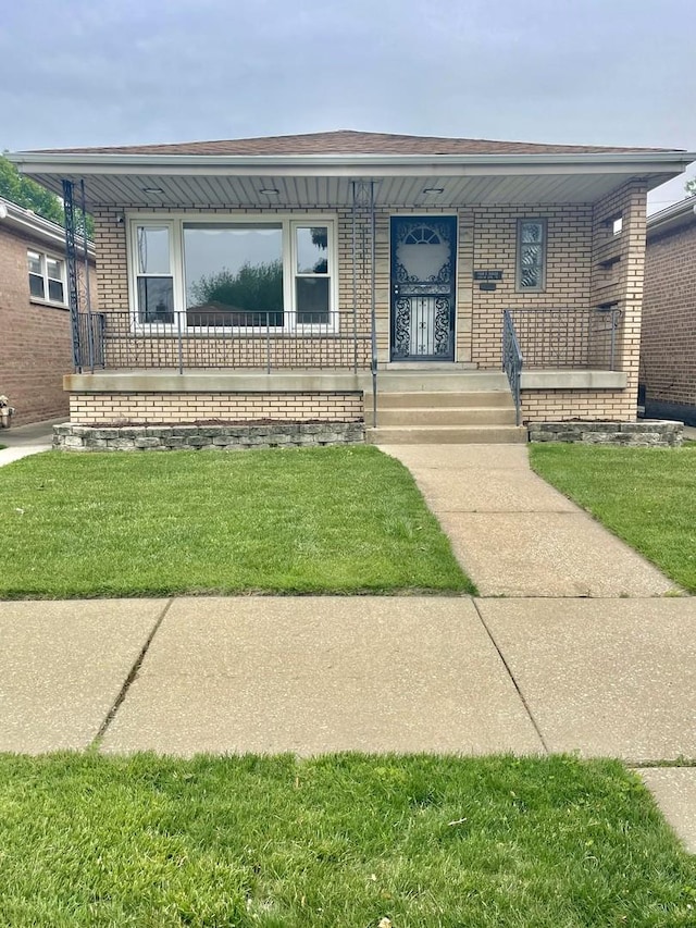 10519 S S Ave E, Chicago, IL 60617 - view of front of home with covered porch, a front lawn, and brick siding