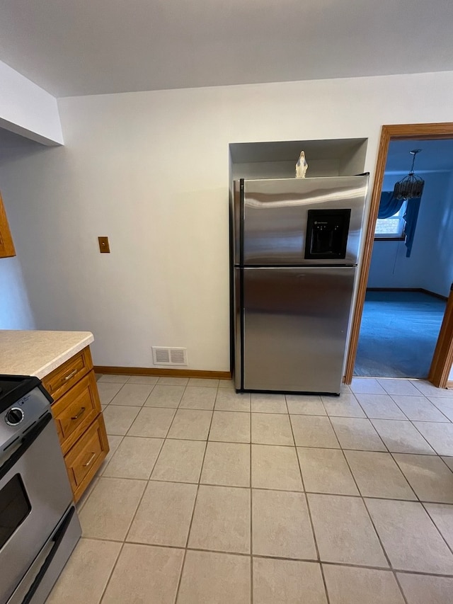 kitchen featuring light tile patterned flooring and appliances with stainless steel finishes