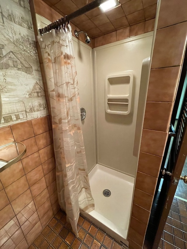 bathroom with tile patterned floors and walk in shower