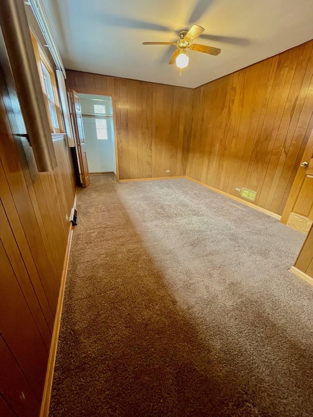 10519 S S Ave E, Chicago, IL 60617 - empty room with carpet, a ceiling fan, and wood walls