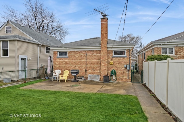 back of property featuring a lawn and a patio