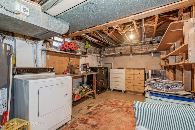 basement with gas water heater, light tile patterned floors, and washer / clothes dryer