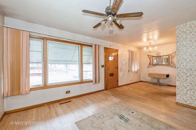 entrance foyer featuring wood-type flooring and ceiling fan with notable chandelier