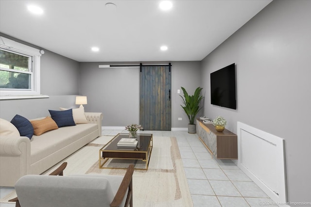 living area with a barn door, light tile patterned flooring, recessed lighting, and baseboards