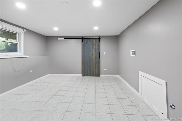 15323 Cherry Ln, Markham, IL 60428 - empty room featuring a barn door, recessed lighting, baseboards, and light tile patterned floors