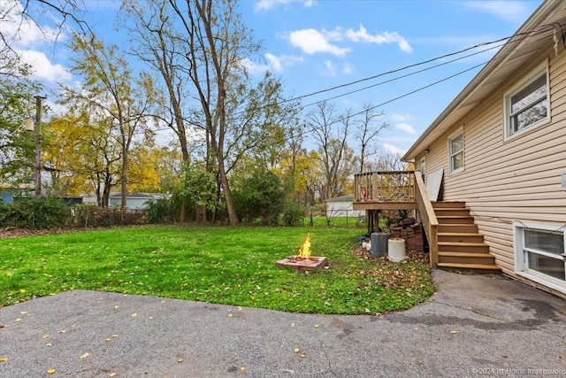 view of yard with a patio area, stairway, a fire pit, and a deck