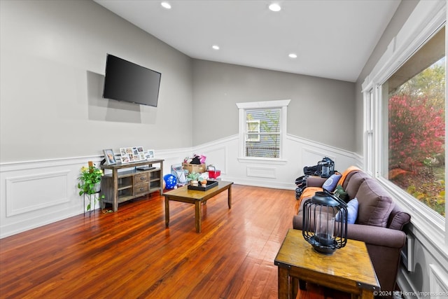 living area with hardwood / wood-style floors, vaulted ceiling, recessed lighting, and wainscoting